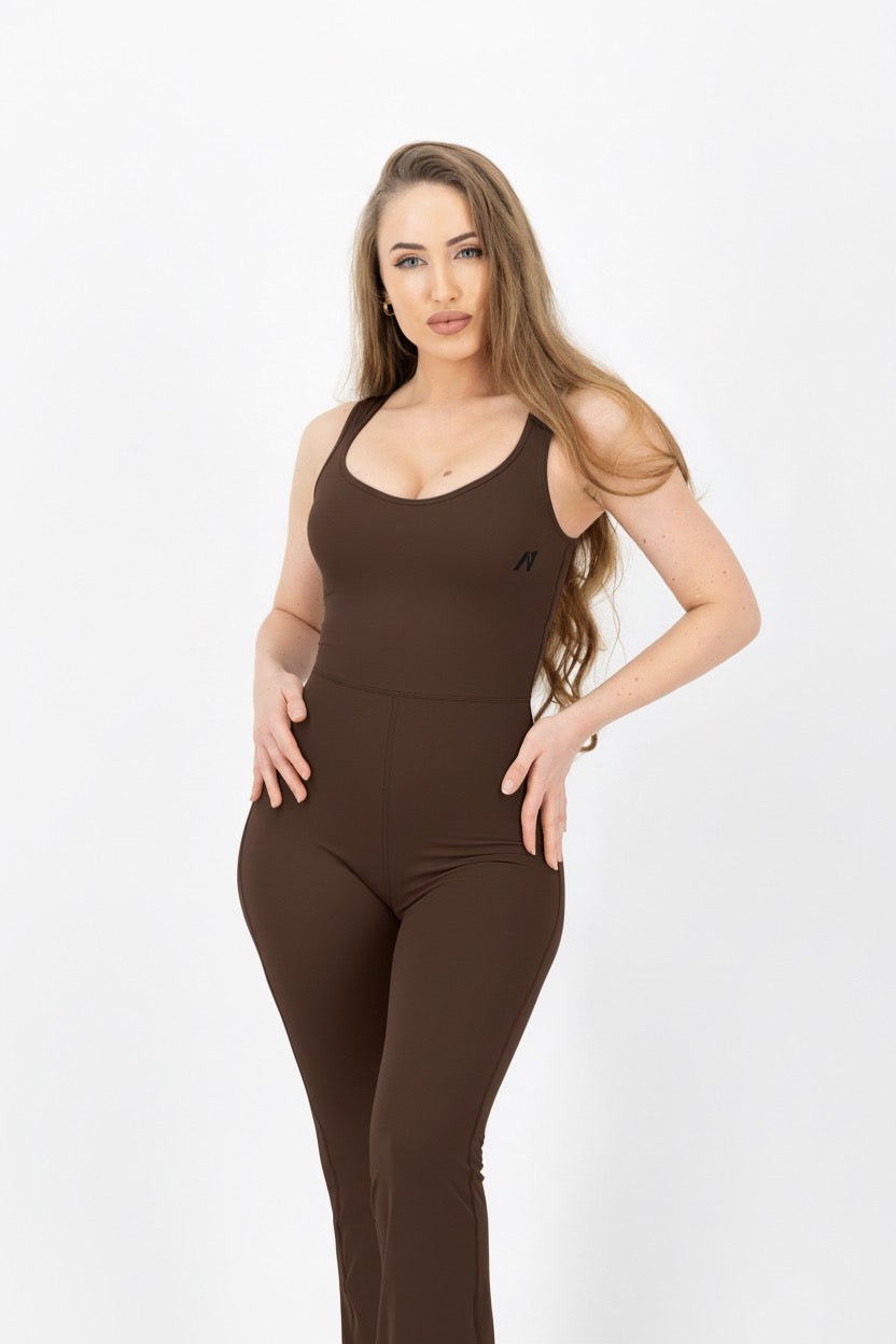 Woman wearing a brown jumpsuit on a white background